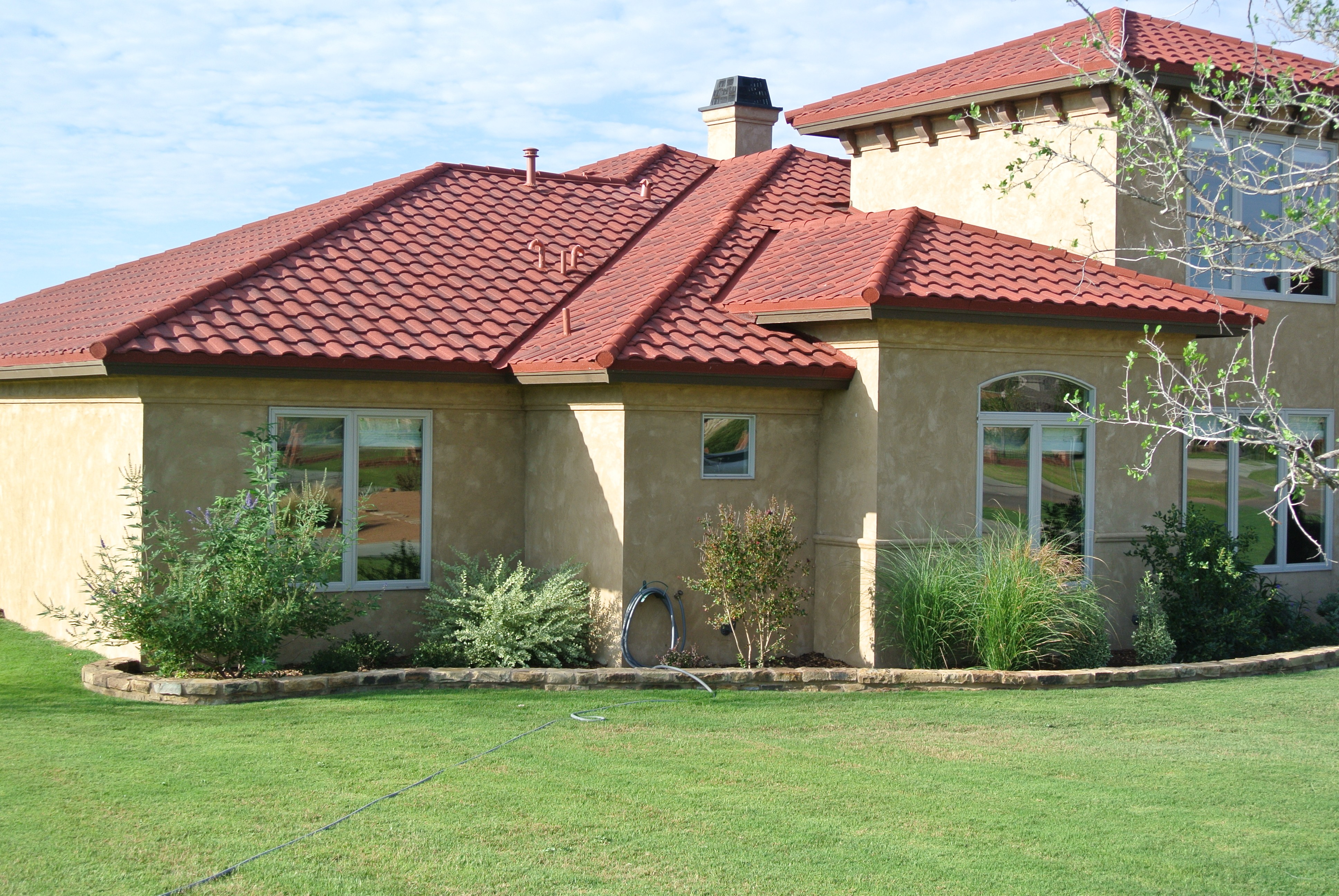 Gerard Barrel Vault Barcelona stone-coated steel on stucco home