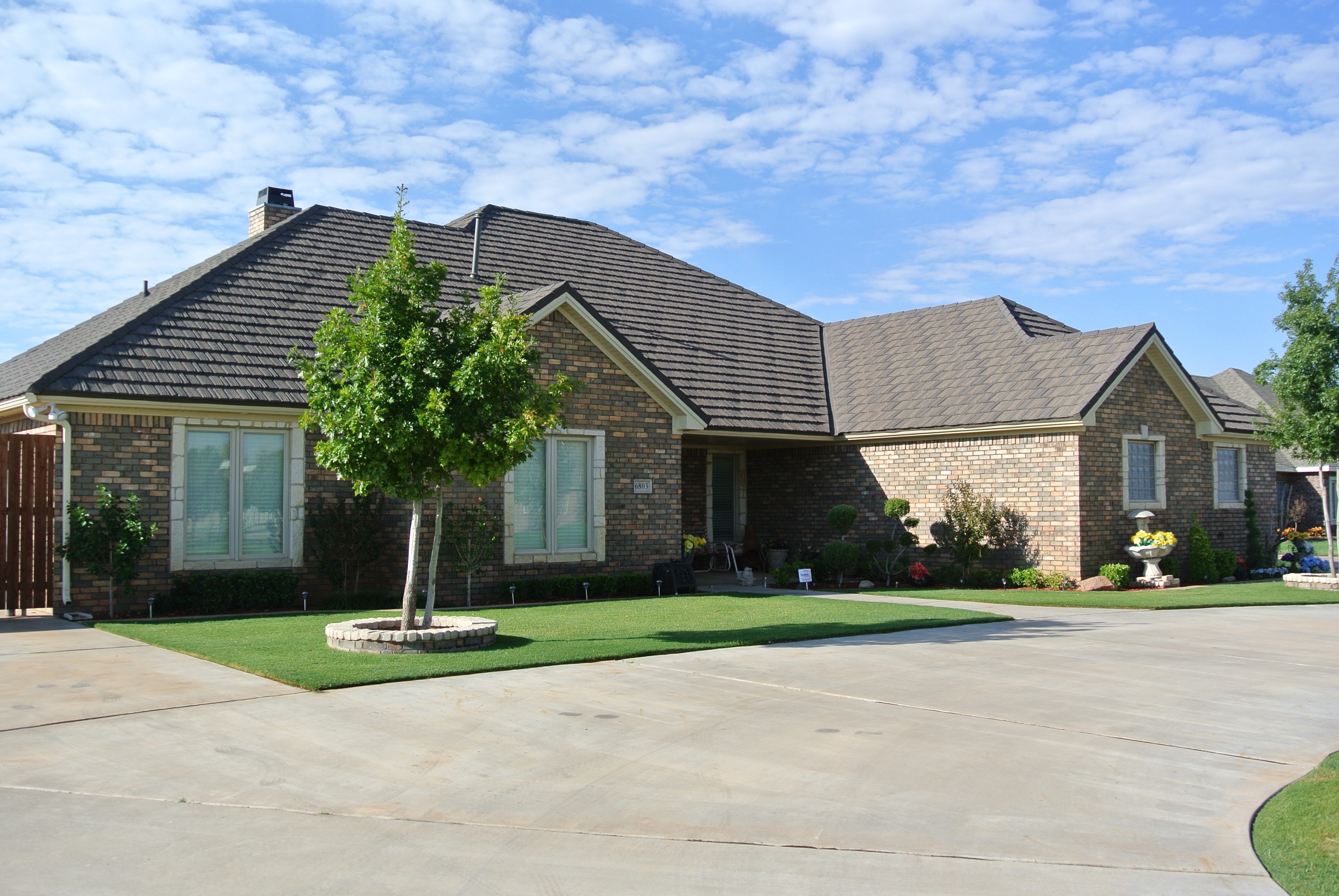 Completed roof replacement on brick home, Tudor style